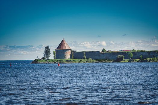 View of the old stone fortress with a watchtower. Fortress Oreshek on a sunny summer day