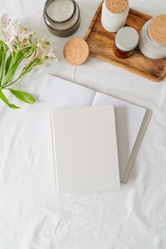 Blank white book, coffee , flowers on white bed, flat lay, mock up, flat lay
