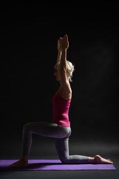 Woman exercising pilates. Kneeling position.