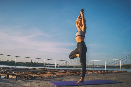 Woman practicing yoga on sunny day. Vriksasana, Tree pose