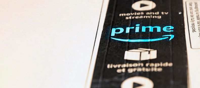 Rome, Italy, June 2021: The Amazon Prime logo printed on the black safety tape on a cardboard box. Packaging for shipping and online shopping. Illustrative editorial