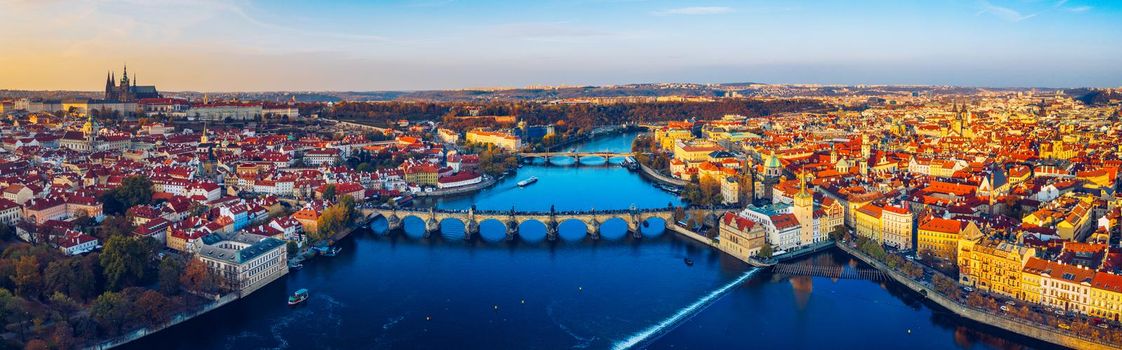 Aerial Prague panoramic drone view of the city of Prague at the Old Town Square, Czechia. Prague Old Town pier architecture and Charles Bridge over Vltava river in Prague at sunset, Czech Republic. 