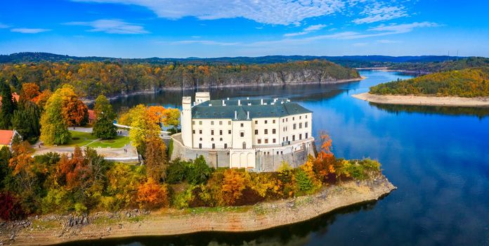 Aerial view chateau Orlik, above Orlik reservoir in beautiful autumn nature. Romantic royal Schwarzenberg castle above water level. Czechia. Orlik castle across the River Vltava, Czech Republic.