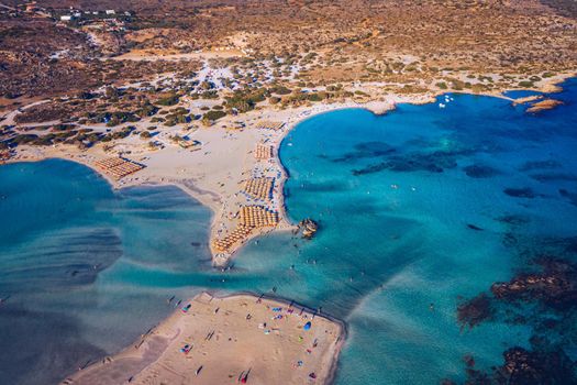 Aerial drone shot of beautiful turquoise beach with pink sand Elafonissi, Crete, Greece. Best beaches of Mediterranean, Elafonissi beach, Crete, Greece. Famous Elafonisi beach on Greece island, Crete.