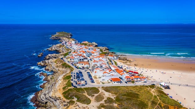 Aerial view of island Baleal naer Peniche on the shore of the ocean in west coast of Portugal. Baleal Portugal with incredible beach and surfers. Aerial view of Baleal, Portugal.