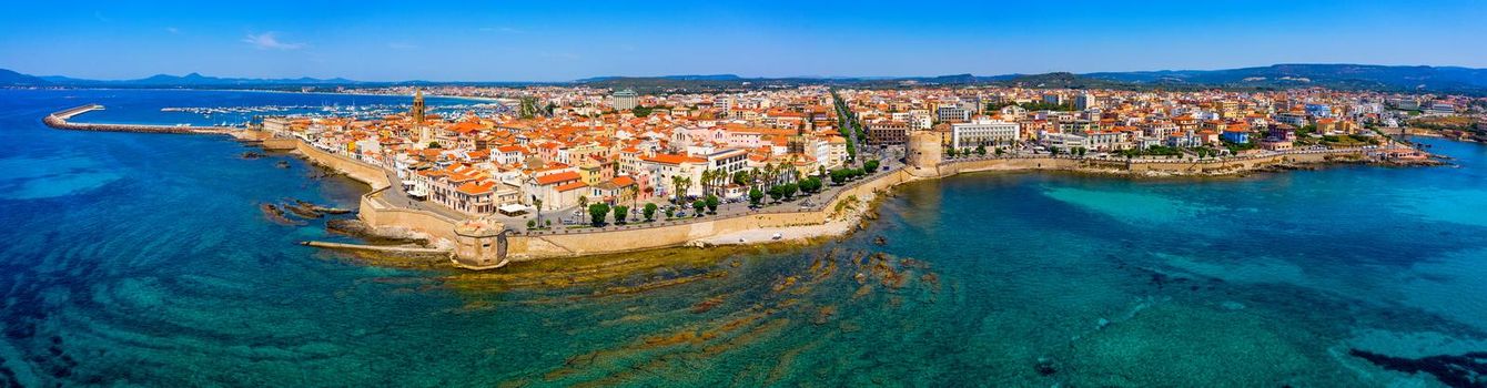 Aerial view over Alghero old town, cityscape Alghero view on a beautiful day with harbor and open sea in view. Alghero, Italy. Panoramic aerial view of Alghero, Sardinia, Italy. 
