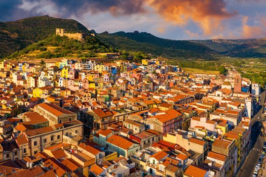 Aerial view of the beautiful village of Bosa with colored houses and a medieval castle. Bosa is located in the north-wesh of Sardinia, Italy. Aerial view of colorful houses in Bosa village, Sardegna.