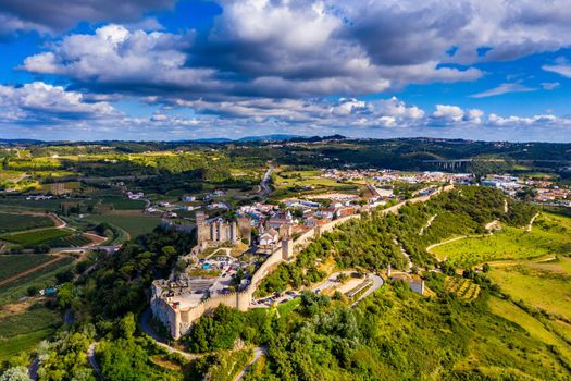 Aerial view of the historic walled town of Obidos at sunset, near Lisbon, Portugal. Aerial shot of Obidos Medieval Town, Portugal. Aerial view of medieval fortress in Obidos. Portugal.