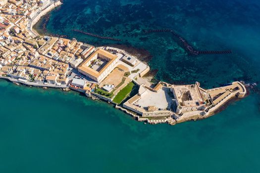 Siracusa, Ortigia Island from the air, Sicily, Italy. Isola di Ortigia, coast of Ortigia island at city of Syracuse, Sicily, Italy. Coastline town Syracuse, Sicily and old Ortigia island. Aerial view.