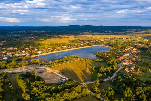 Beautiful Tismana lake and surrounding forest aerial panorama. Tismana, Romania.