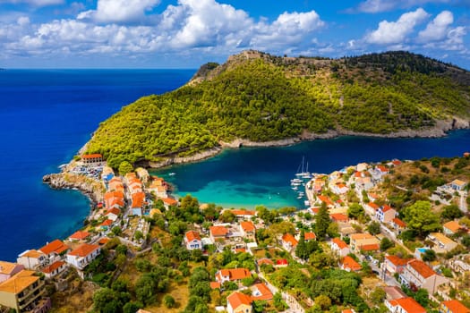 Aerial drone view video of beautiful and picturesque colorful traditional fishing village of Assos in island of Cefalonia, Ionian, Greece. Peninsula of Assos in Cephalonia (Kefalonia), Greece