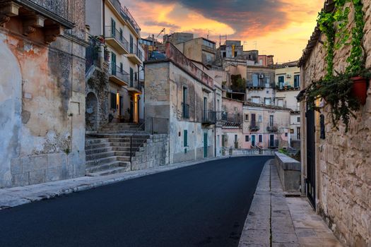 Narrow typical italian old street in Ragusa (Ragusa Ibla), Sicily, Italy , UNESCO heritage town on Italian island of Sicily. View of the city Ragusa Ibla, Val di Noto, Sicily, Italy.  