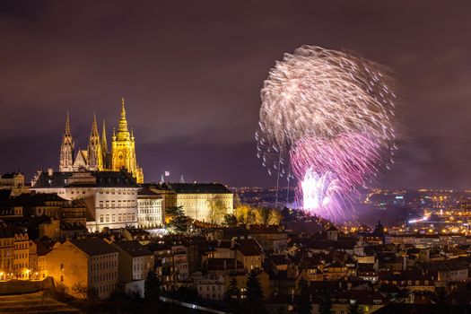Fireworks over the Old Town of Prague, Czech Republic. New Year fireworks in Prague, Czechia. Prague fireworks during New Year Celebration near St. Vitus Cathedral, Prague, Czech republic.