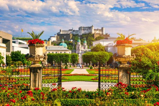 Beautiful view of famous Mirabell Gardens with the old historic Fortress Hohensalzburg in the background in Salzburg, Austria. Famous Mirabell Gardens with historic Fortress in Salzburg, Austria.