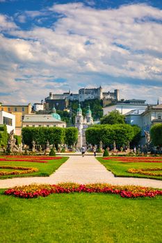 Beautiful view of famous Mirabell Gardens with the old historic Fortress Hohensalzburg in the background in Salzburg, Austria. Famous Mirabell Gardens with historic Fortress in Salzburg, Austria.