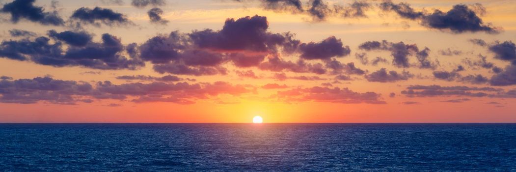 Beautiful sunset/sunrise over the sea. Beautiful sunset over the ocean. Beautiful sunset over sea with reflection in water, majestic clouds in the sky