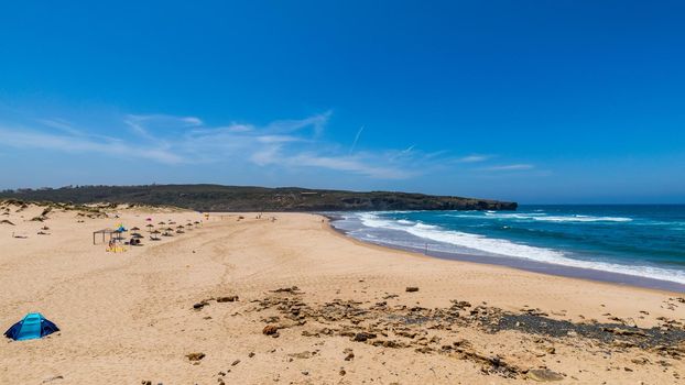 Wooden walkway to the beach Praia da Amoreira, District Aljezur, Algarve Portugal. Panorama from Amoreira beach in the Algarve Portugal. Beach and estuary of the Aljezur river, Praia da Amoreira.