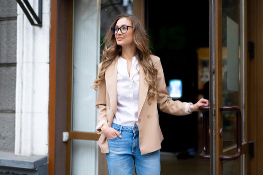 Business Woman Come Out Store Door Outside Caucasian Female Business Person Standing Near Shop Doorway Dressed Blue Jeans Jacket Glasses Holding Doorhandle