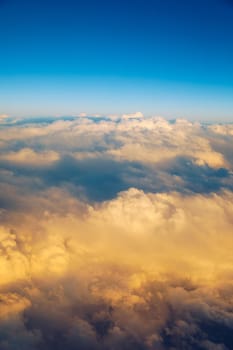 Sunny sky abstract background, beautiful cloudscape, on the heaven, view over white fluffy clouds, freedom concept. Aerial view of sky and white clouds. View from airplane. 