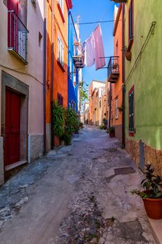 Street view of the beautiful village of Bosa with colored houses and a medieval castle. Bosa is located in the north-wesh of Sardinia, Italy. Street view of colorful houses in Bosa village, Sardegna.