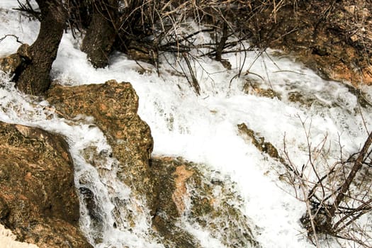 The Cabriel River with crystal clear waters and surrounded by green vegetation in the mountains of Albacete, Spain