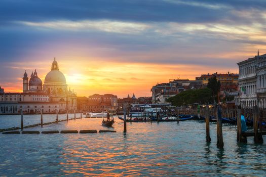 Sunset in Venice. Image of Grand Canal in Venice, with Santa Maria della Salute Basilica in the background. Venice is a popular tourist destination of Europe. Venice, Italy.