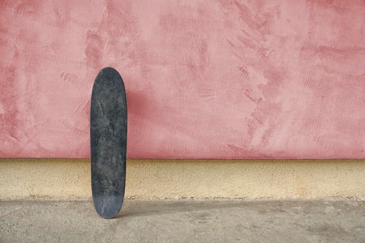 Skateboard on a wall. Used skateboard.