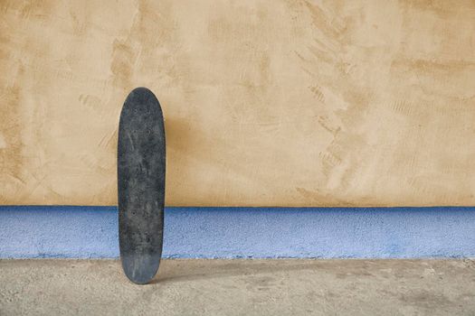 Skateboard on a wall. Used skateboard.