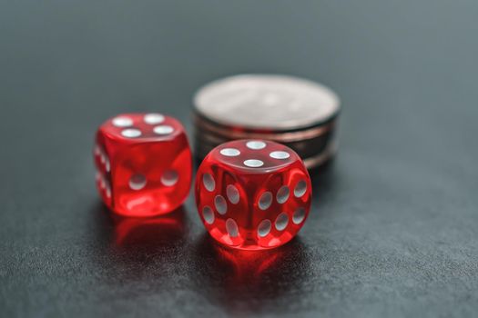 Red dice and chips lie on the gambling table for the casino. Casino gambling and home entertainment