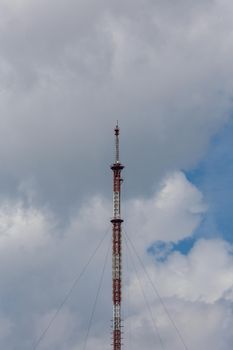 tall metal frame television tower on cloudy sky daylight background.