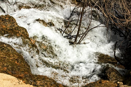 The Cabriel River with crystal clear waters and surrounded by green vegetation in the mountains of Albacete, Spain