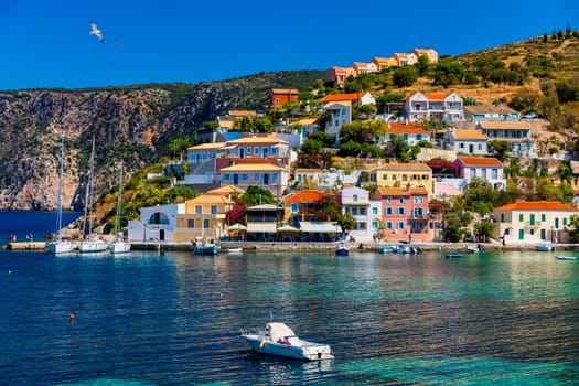 Assos village in Kefalonia, Greece. Turquoise colored bay in Mediterranean sea with beautiful colorful houses in Assos village in Kefalonia, Greece, Ionian island, Cephalonia, Assos village.