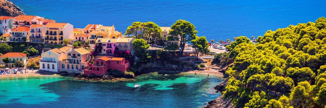 Assos village in Kefalonia, Greece. Turquoise colored bay in Mediterranean sea with beautiful colorful houses in Assos village in Kefalonia, Greece, Ionian island, Cephalonia, Assos village.