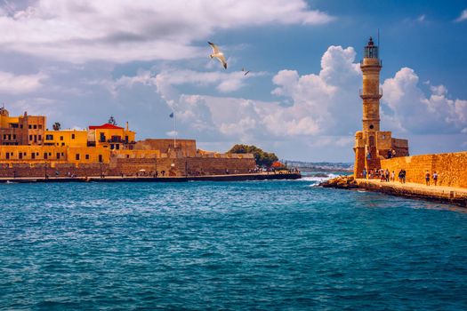 Panorama of venetian harbour waterfront and lighthouse in old harbour of Chania, Crete, Greece. Old venetian lighthouse in Chania, Greece. Lighthouse of the old Venetian port in Chania, Greece.