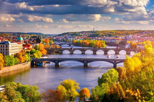 Autumn view to Charles bridge on Vltava river in Prague, Czech Republic. Autumn view to Charles Bridge, Prague old town and Vltava river from popular view point in the Letna park (Letenske sady).