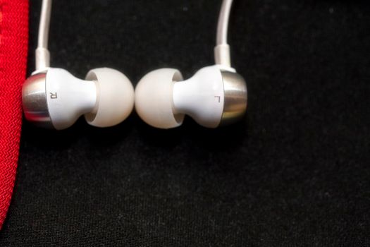 White Headphones for ears. On a black background