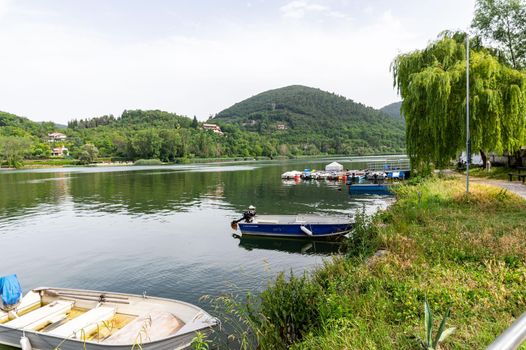 piediluco,italy june 23 2021:piediluco lake with boats by the lake