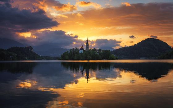 Lake Bled Slovenia. Beautiful sunrise over Bled lake with small Pilgrimage Church. Most famous Slovenian lake and island Bled with Pilgrimage Church of the Assumption of Maria. Bled, Slovenia.
