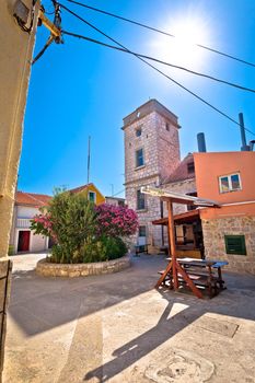 Mediterranean stone village on Krapanj island square and tower view, sea sponge harvesting village, Sibenik archipelago of Croatia
