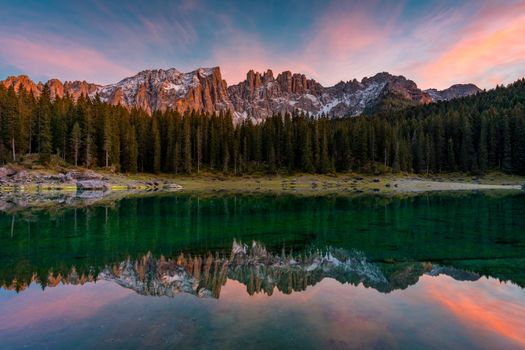 Carezza lake (Lago di Carezza, Karersee) with Mount Latemar, Bolzano province, South tyrol, Italy. Landscape of Lake Carezza or Karersee and Dolomites in background, Nova Levante, Bolzano, Italy.