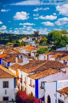 Historic walled town of Obidos, near Lisbon, Portugal. Beautiful streets of Obidos Medieval Town, Portugal. Street view of medieval fortress in Obidos. Portugal.