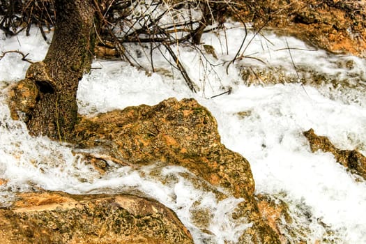 The Cabriel River with crystal clear waters and surrounded by green vegetation in the mountains of Albacete, Spain
