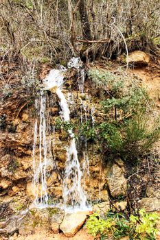 Waterfall in leafy forest in Spain in Spring