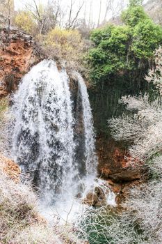 Waterfall called El Salto del Caballo and The Alcaraz river crossing the natural site of Los Batanes, Alcaraz, Albacete, Spain