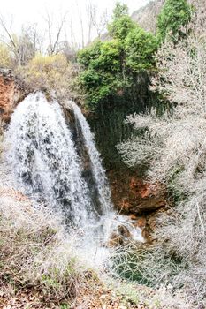 Waterfall called El Salto del Caballo and The Alcaraz river crossing the natural site of Los Batanes, Alcaraz, Albacete, Spain