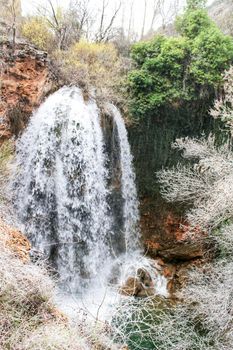 Waterfall called El Salto del Caballo and The Alcaraz river crossing the natural site of Los Batanes, Alcaraz, Albacete, Spain