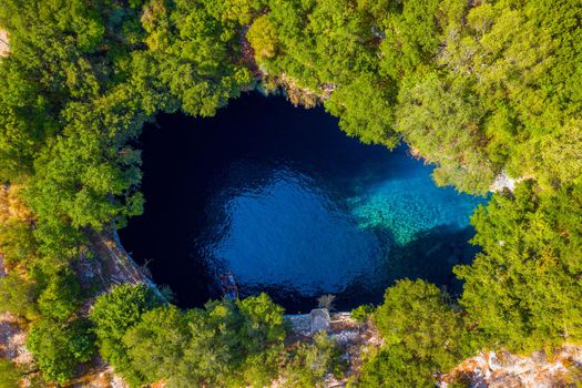 Famous Melissani lake on Kefalonia island, Karavomylos, Greece. On top of Melissani Cave (Melissani Lake) in Karavomylos village in Kefalonia island , Greece. Melissani Cave viewed from above.