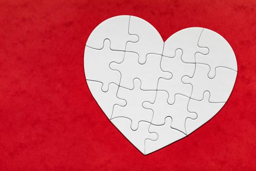 Heart object made of puzzle pieces. Make complete heart. Jigsaw puzzle pieces in form of heart. Happy Valentines Day, greeting card template. Heart jigsaw puzzle.