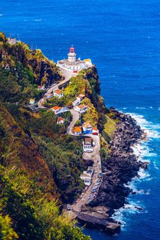 Dramatic view down to lighthouse on Ponta do Arnel, Nordeste, Sao Miguel Island, Azores, Portugal. Lighthouse Arnel near Nordeste on Sao Miguel Island, Azores, Portugal. 