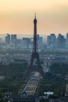 View of Paris with Eiffel Tower from Montparnasse building. Eiffel tower view from Montparnasse at sunset, view of the Eiffel Tower and La Defense district in Paris, France.